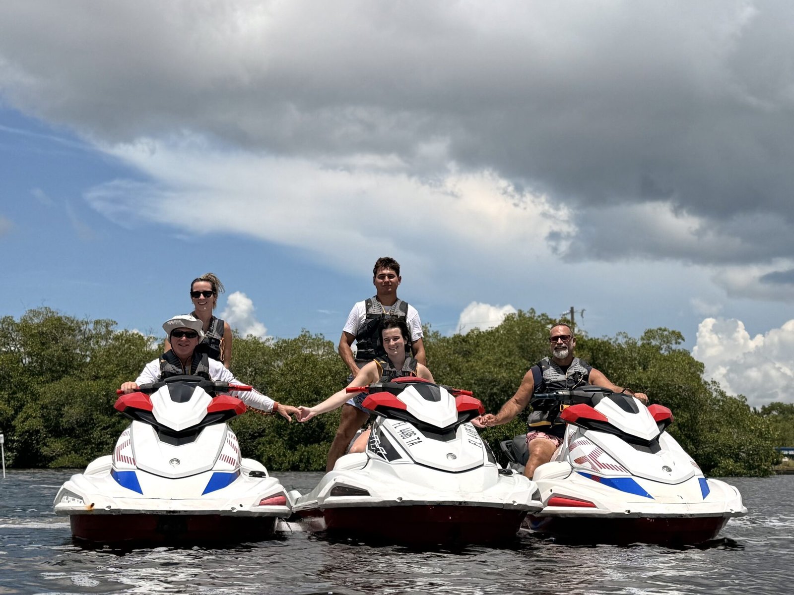 Jet ski riders along the mangrove shoreline near the Sanibel Causeway